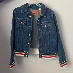 Like new! White red and blue stripes around the bottom and around the sleeves.